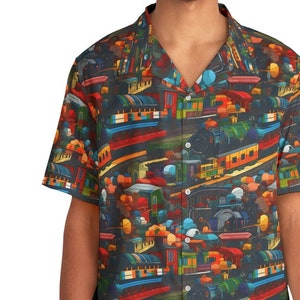 May include: A short-sleeved button-down shirt with a colorful print of toy trains and other train-related objects on a dark blue background.