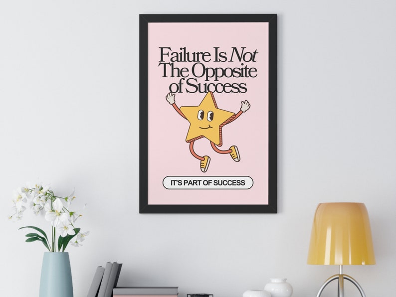 Vintage-inspired framed poster with the phrase 'Failure Is Not The Opposite of Success It's Part of Success' featuring a whimsical font and playful illustrations of a star.