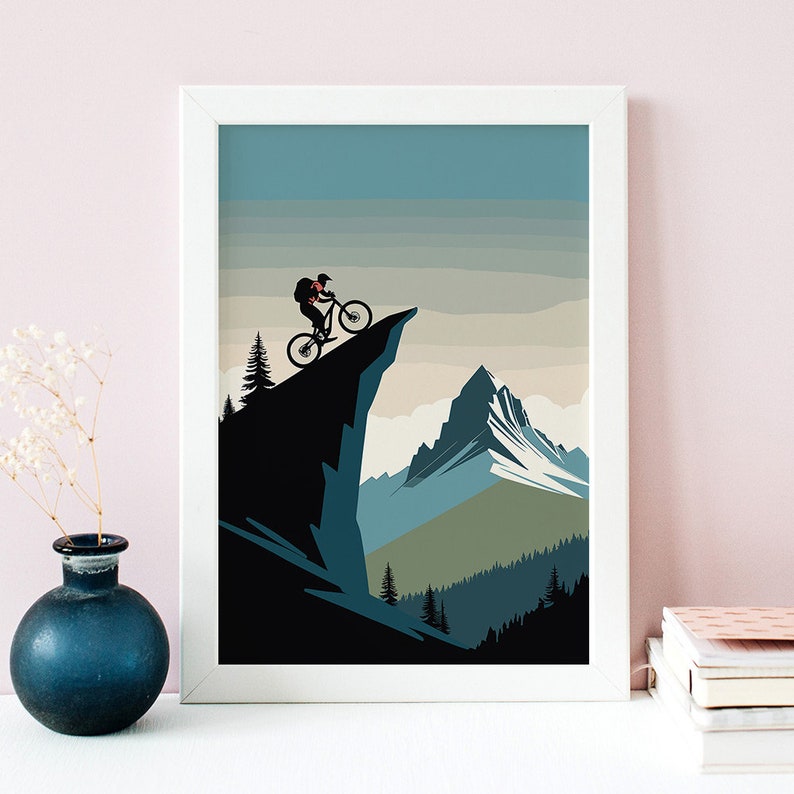 May include: A silhouette of a mountain biker riding down a cliff edge with a mountain range in the background. The sky is a light blue with a gradient of white clouds.