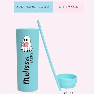 May include: A light blue tumbler with a matching lid and straw. The tumbler features a cartoon ghost reading a book and the name "Melissa Saenz". Text at the top says "ADD NAME, LOGO OR IMAGE". The bottom text says "Follow me @MOONDREAM_NJ".