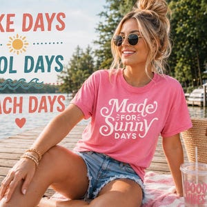 May include: A bright pink short-sleeved t-shirt with white cursive text that reads Made FOR Sunny DAYS. The shirt is paired with blue denim shorts. The graphic text LAKE DAYS, POOL DAYS, and BEACH DAYS appears in the upper left corner.