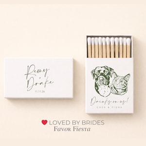 May include: White matchbox with the names "Remy Drake" and date "11.11.26" in green script. The open matchbox features a dog and cat illustration with the text "Drinks on us!" and names "Cash & Fiona".