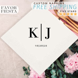 May include: White paper napkin with black text that reads "K|J 10|20|25". The napkin is on a table with pink flowers and green leaves.