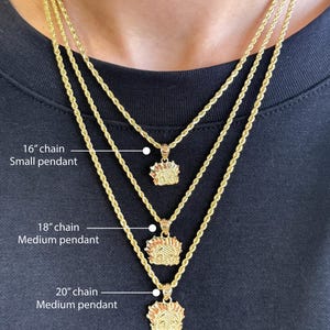May include: Three gold rope chains with pendants. The chains are 16 inches, 18 inches, and 20 inches long. The pendants are small and medium in size.