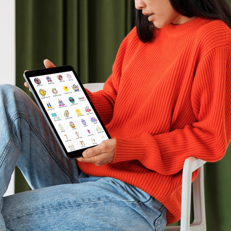 May include: A digital tablet displaying a grid of colorful icons representing various holidays and events. The icons include a US flag, a birthday cake, a Christmas tree, a graduation cap, and more.