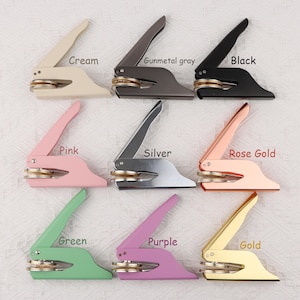 May include: Nine different colored self-inking stamps with a round seal. The colors are cream, gunmetal gray, black, pink, silver, rose gold, green, purple, and gold.