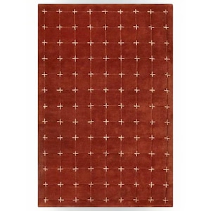May include: A rectangular area rug in a deep terracotta red color featuring a grid pattern formed by thin, light cream-colored lines that intersect at regular intervals to create a series of uniform squares across the entire surface.