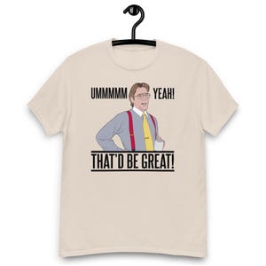 May include: A beige t-shirt with a cartoon image of a man in glasses, a yellow tie, and red braces. The text on the shirt says "Ummmmm Yeah! That'd Be Great!"