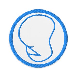May include: Embroidered patch with a white center and a blue outline. The patch features a blue abstract design within the white circle. The patch is round and has a stitched texture.