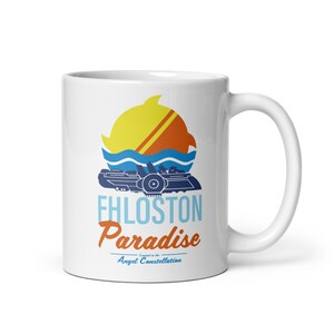 May include: A white ceramic mug featuring a graphic of a yellow sun, blue waves, and a dark blue spaceship. The text reads Fhloston Paradise Located in the Angel Constellation in light blue and orange lettering on the front of the mug.