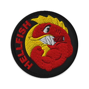 May include: Embroidered patch featuring a red, muscular cartoon character with a cigar, set against a yellow sunburst. The character has a fierce expression with clenched teeth. The words "HELLFISH" are embroidered around the black border.