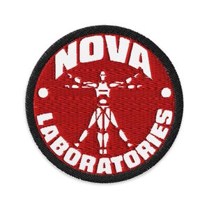 May include: Embroidered patch with a red background and black border. The patch features the text "NOVA LABORATORIES" in white, encircling a white stylized human figure with outstretched arms.