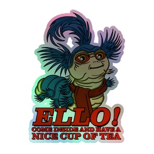 May include: A holographic sticker featuring a blue caterpillar-like creature with large eyes, a red scarf, and spiky hair. The text below reads ELLO! COME INSIDE AND HAVE A NICE CUP OF TEA in bold red letters against a shimmering, iridescent background.