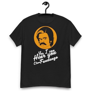 May include: Black t-shirt with a yellow circle featuring a cartoon illustration of a man with a mustache and the text "Yes I can Hear you Clem Fandango".