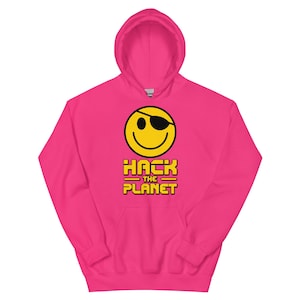 May include: A vibrant pink hoodie with a yellow smiley face wearing a black eye patch. The text "HACK THE PLANET" is printed in yellow below the smiley. The hoodie has a front pocket and a drawstring hood.