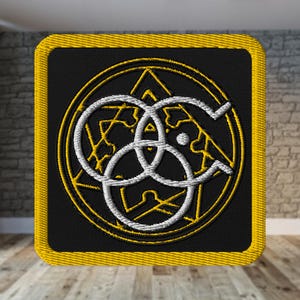 May include: Embroidered patch with a black background and a yellow border. The design features a white and yellow geometric symbol within a yellow circle and triangle. The patch is square.