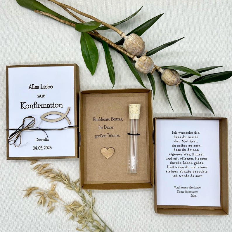 May include: Two small gift boxes with brown paper wrapping. The box on the left has a white card with the text "Alles Liebe zur Konfirmation" and a wooden fish symbol. The box on the right has a white card with a message of encouragement and a small glass tube with a cork stopper.