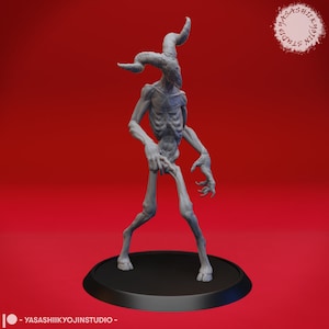 May include: A grey, detailed, 3D printed miniature of a humanoid figure with horns and clawed hands. The figure is standing on a black circular base.