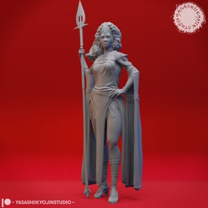 May include: A gray 3D printed figurine of a woman warrior holding a spear. She is wearing a flowing robe and has a determined expression on her face.