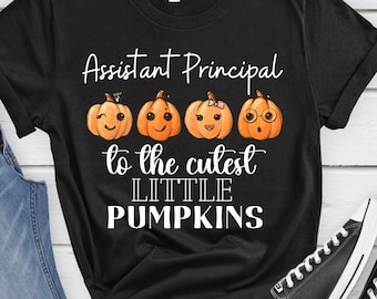 May include: Black t-shirt with the text "Assistant Principal to the cutest little pumpkins" and four cartoon pumpkins with different facial expressions.
