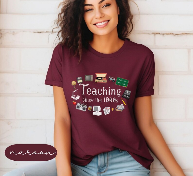 May include: A maroon t-shirt with a white graphic of various retro technology items and the text "Teaching since the 1900s".