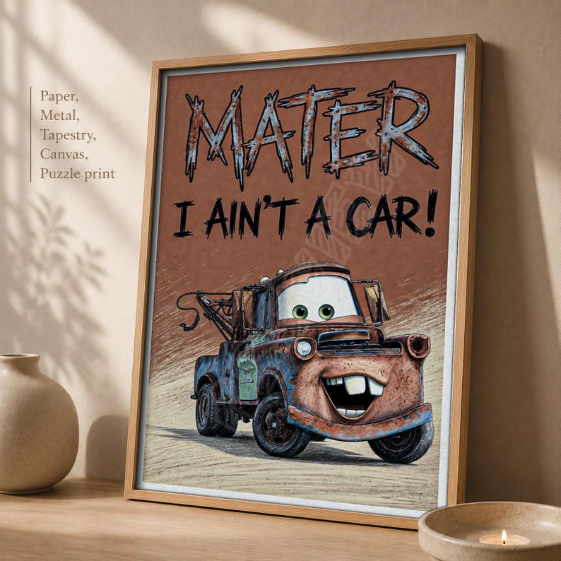 May include: A framed wall art print featuring the character Mater from the movie Cars. The image shows a rusty brown tow truck with green eyes and a wide smile. The text MATER and I AIN'T A CAR! is printed in large, stylized black lettering.