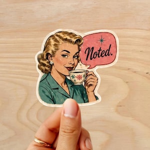 Może przedstawiać: Naklejka w stylu retro z ilustracją w stylu vintage kobiety trzymającej filiżankę herbaty. Ma na sobie turkusowy top i blond włosy. R&oacute;żowy dymek nad jej głową m&oacute;wi "Noted."