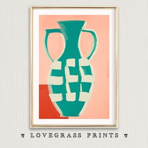 May include: Abstract art print featuring a teal vase with white checkered pattern and handles, set against a coral background. A gold frame surrounds the artwork. The bottom of the print has the text "& LOVEGRASS PRINTS &"