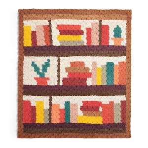 May include: A crocheted blanket with a bookshelf design. The blanket depicts three shelves filled with colourful, stacked books and potted cacti. The colour palette includes shades of brown, cream, red, yellow, and green, creating a cosy and inviting aesthetic.