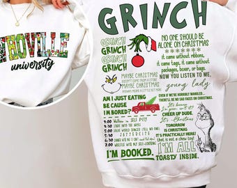 May include: White sweatshirt featuring the text "Whoville University" in a colorful, floral design on the front. The back of the sweatshirt has a Grinch-themed design with quotes and illustrations, perfect for Christmas.