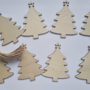May include: Ten unfinished wooden Christmas tree decorations. The decorations are all the same size and shape, and they have a star on top.
