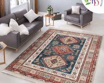 May include: A rectangular area rug with a central dark blue field featuring geometric patterns in red, beige, and white. The rug has a cream-colored border with intricate designs and a fringed edge, suitable for a living room.