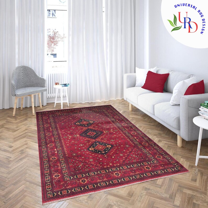 May include: A red, black, and gold patterned rug with a traditional Persian design. The rug is laid out on a hardwood floor in a living room setting.