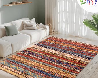 May include: A colorful area rug with a geometric pattern in shades of red, blue, yellow, and cream. The rug has a striped design with intricate details.