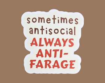 May include: A white sticker with the words "sometimes antisocial ALWAYS ANTI-FARAGE" in a mix of brown and red fonts. The sticker has a rounded, irregular shape and is set against a brown background.