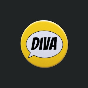 May include: A circular, yellow badge featuring the word "DIVA" in black, within a white speech bubble. The badge has a shiny surface and is set against a dark grey backdrop.