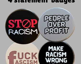 May include: Four statement badges with anti-racism messages. The badges are round and feature bold text in various colors. Messages include "STOP RACISM," "PEOPLE OVER PROFIT," "FUCK FASCISM," and "MAKE RACISM WRONG AGAIN."