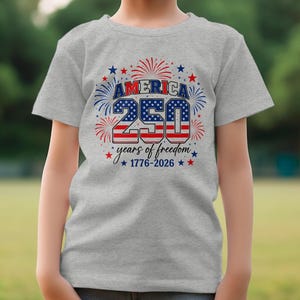 Gray t-shirt with "America 250 years of freedom 1776-2026" text.