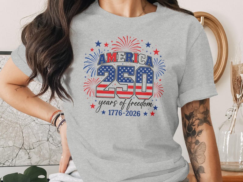 Gray t-shirt with "America 250 years of freedom 1776-2026" in red, white, and blue.