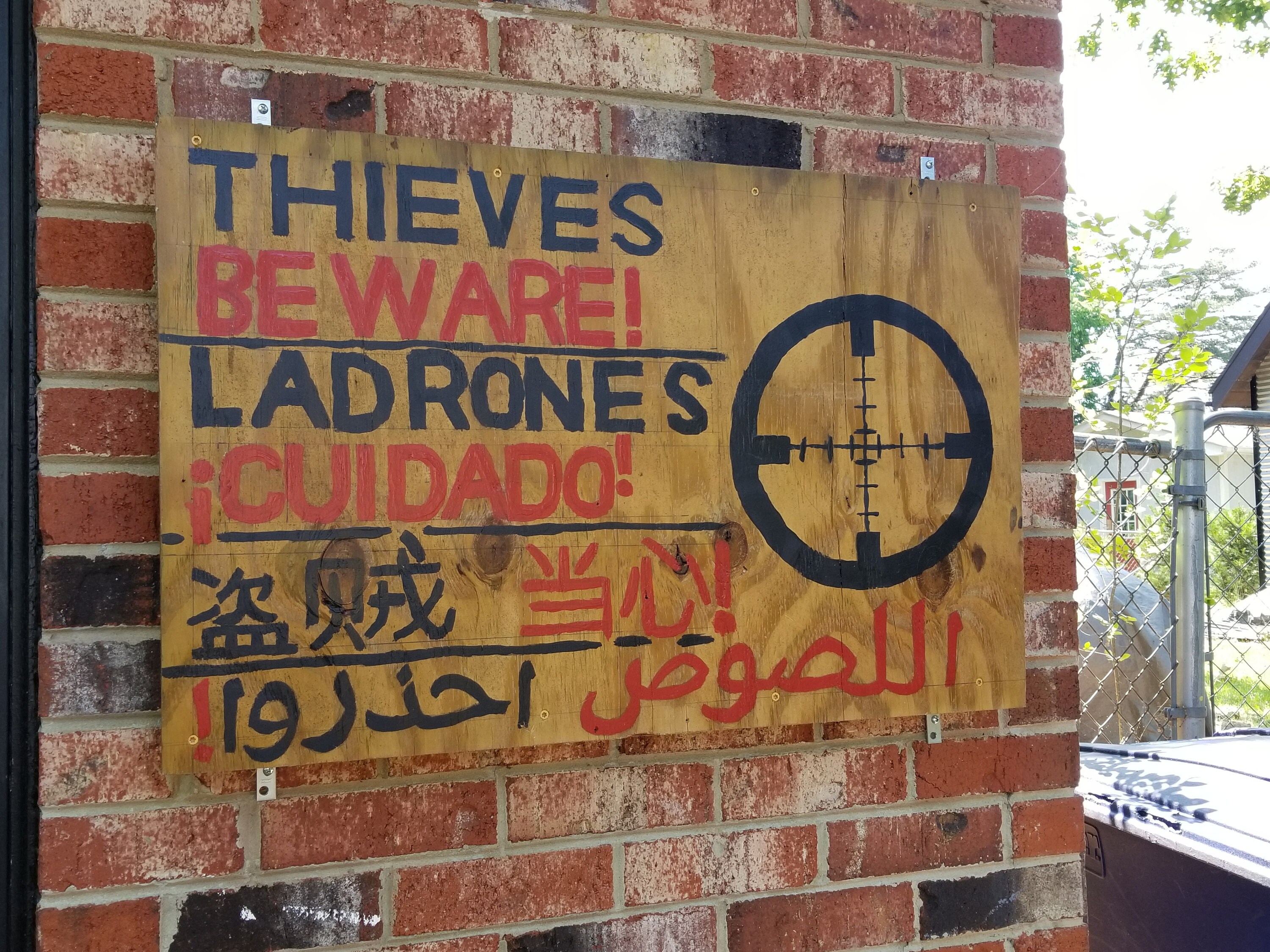 Thieves Beware No Trespassing Sign in English Spanish Chinese and Arabic