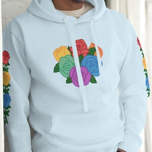 May include: A light blue hoodie with a rainbow rose design on the front and rainbow roses on the sleeves.