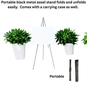 May include: A black metal easel stand with a white display surface. The stand is portable and folds for easy storage. The image also shows a carrying case and the word "Portable".