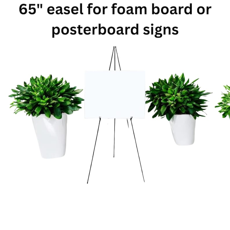May include: A black metal easel, 65 inches tall, holds a white foam board. The easel is displayed against a white background, flanked by white pots with green plants. Text at the top reads: "65" easel for foam board or posterboard signs."