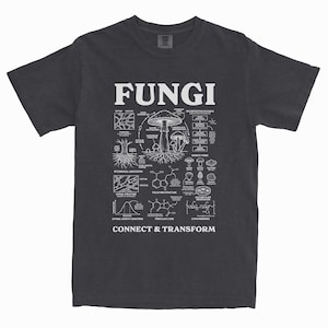 May include: Dark grey t-shirt with a white graphic design. The design features the word "FUNGI" and illustrations of mushrooms, roots, and scientific diagrams. The text "CONNECT & TRANSFORM" is at the bottom.