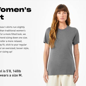 a woman wearing a gray shirt and white pants