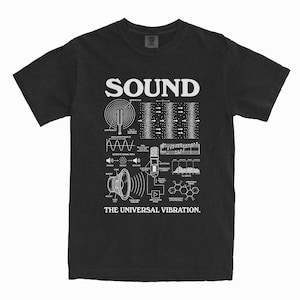 May include: Black t-shirt featuring a white graphic design about sound. The word "SOUND" is at the top, with diagrams of sound waves, a speaker, and a microphone. The text "THE UNIVERSAL VIBRATION" is at the bottom.