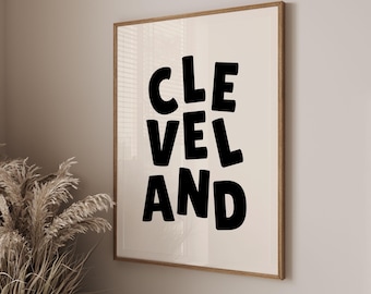 Puede incluir: Una impresión enmarcada con la palabra "CLEVELAND" en letras negras y en negrita sobre un fondo blanco.