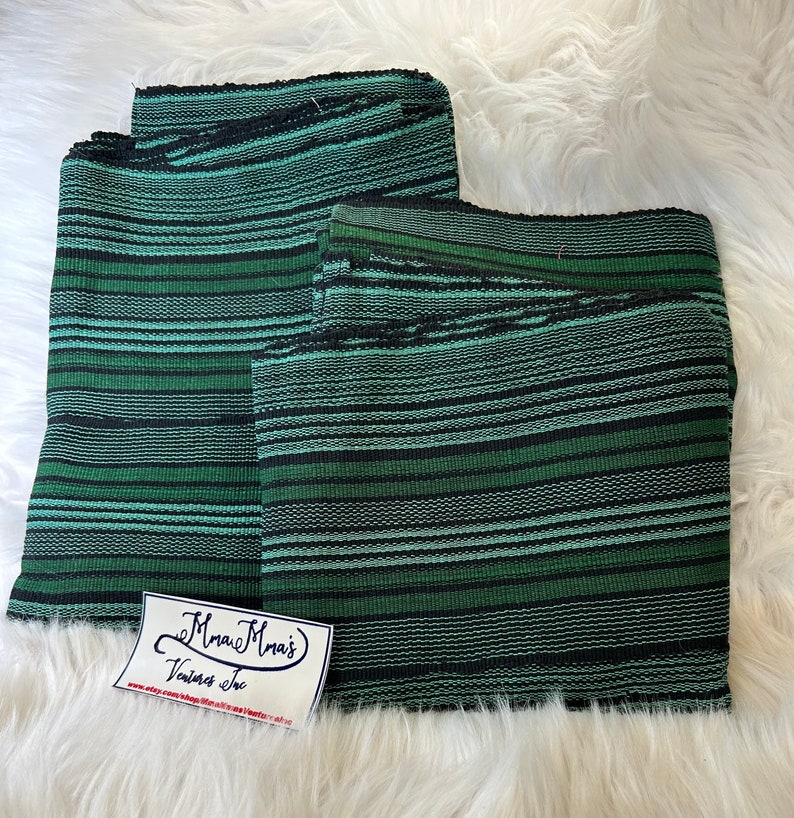 May include: Two pieces of green and black striped fabric. The fabric is woven with a textured pattern. The fabric is folded in half and a small white label with the text "Mama Mma's Vintage Inc" is attached to the fabric.