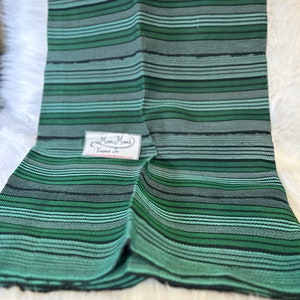 May include: Green and black striped fabric with a small white tag that says "Mimi's Threads".