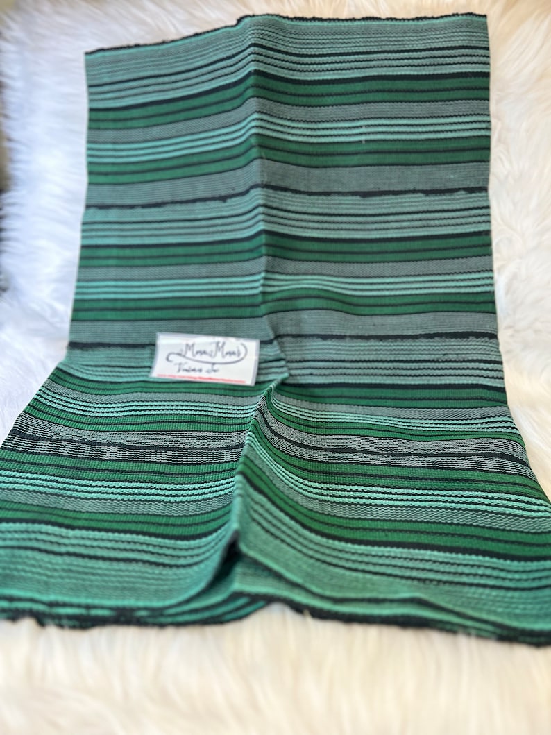 May include: Green and black striped fabric with a small white tag that says "Mimi's Threads".